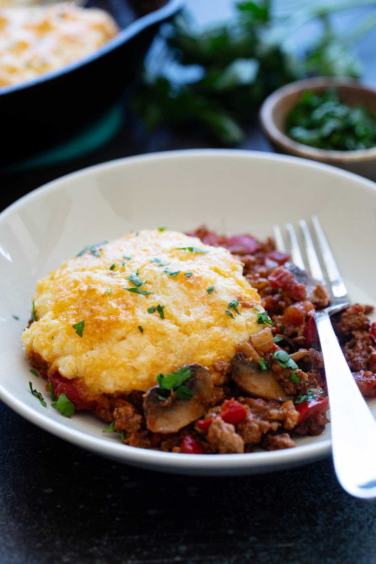 Serving of Skillet Turkey Pot Pie in a shallow bowl.