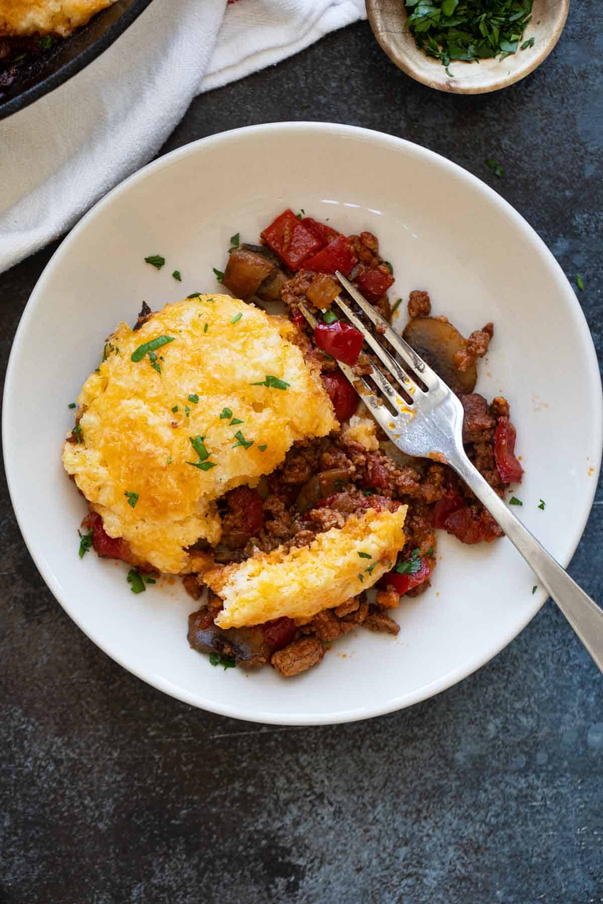 Serving of skillet turkey pot pie with a fork.