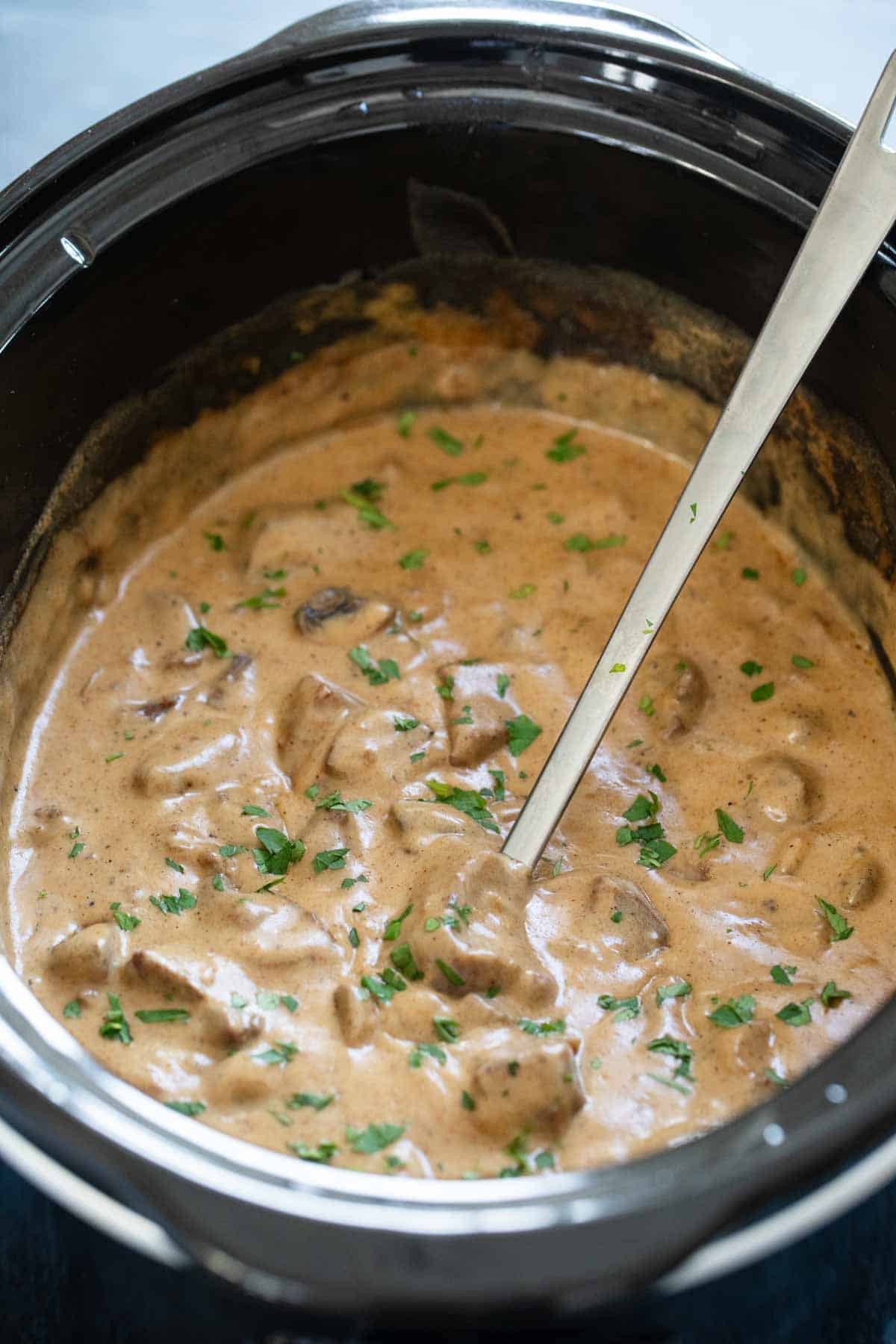 Slow cooker full of beef stroganoff.