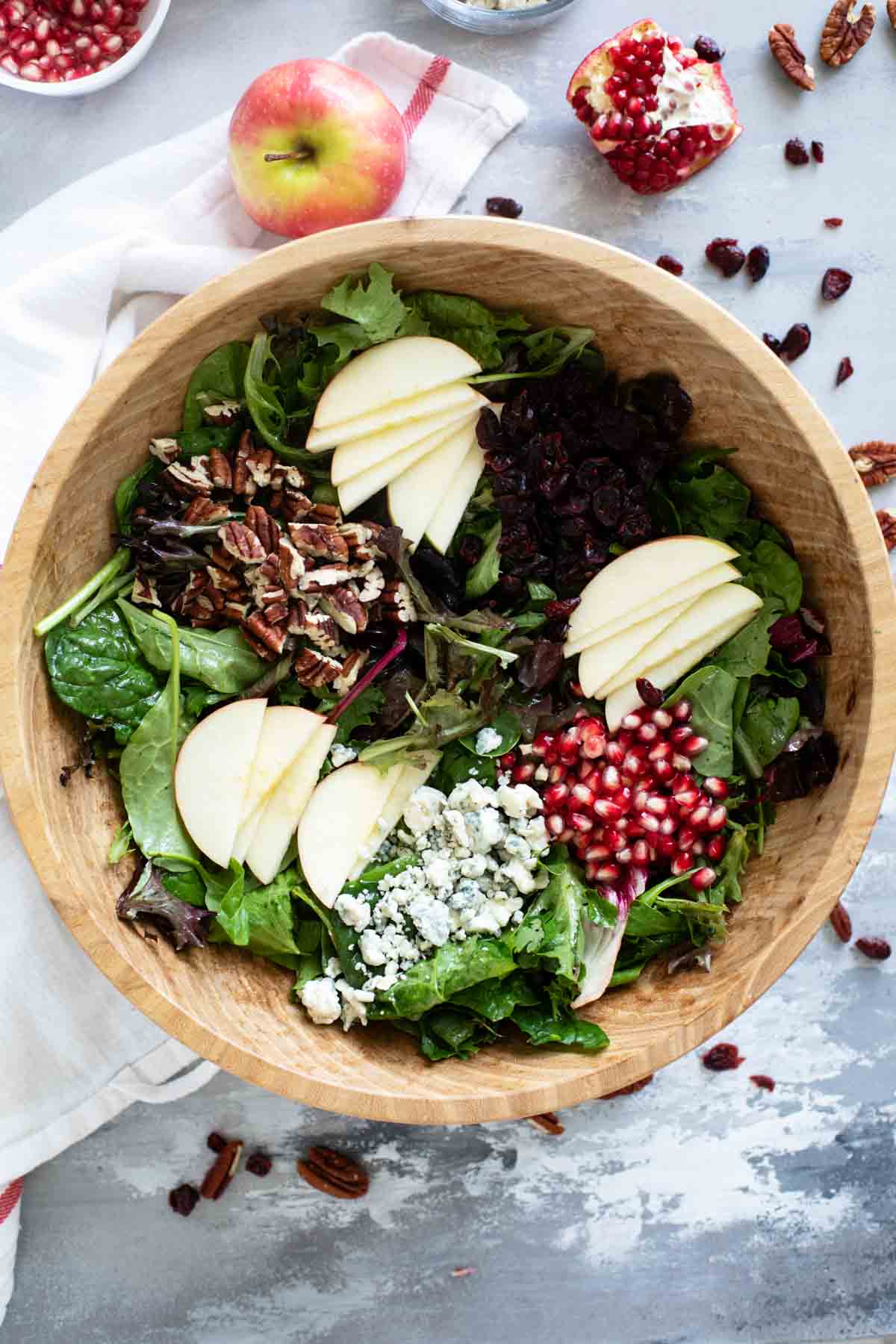 Thanksgiving Salad with apples, pomegranates, dried cranberries, blue cheese, and pecans.