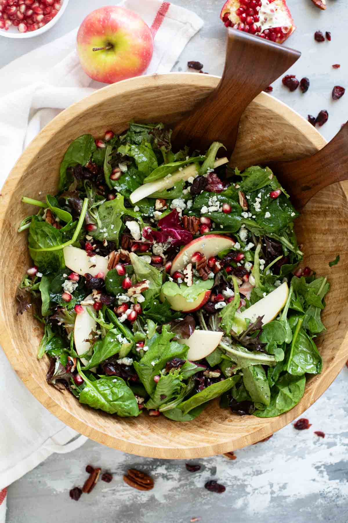 Thanksgiving Salad in a wooden bowl with wooden salad tongs.