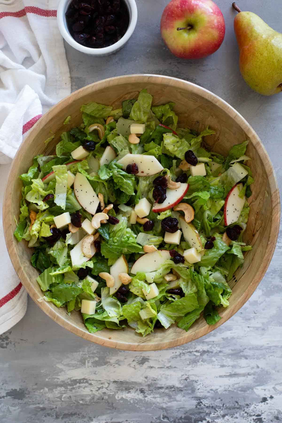 Wooden bowl filled with Winter Salad with Lemon Poppy Seed Dressing.