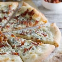 Blue Cheese and Bacon Pizza cut into slices.
