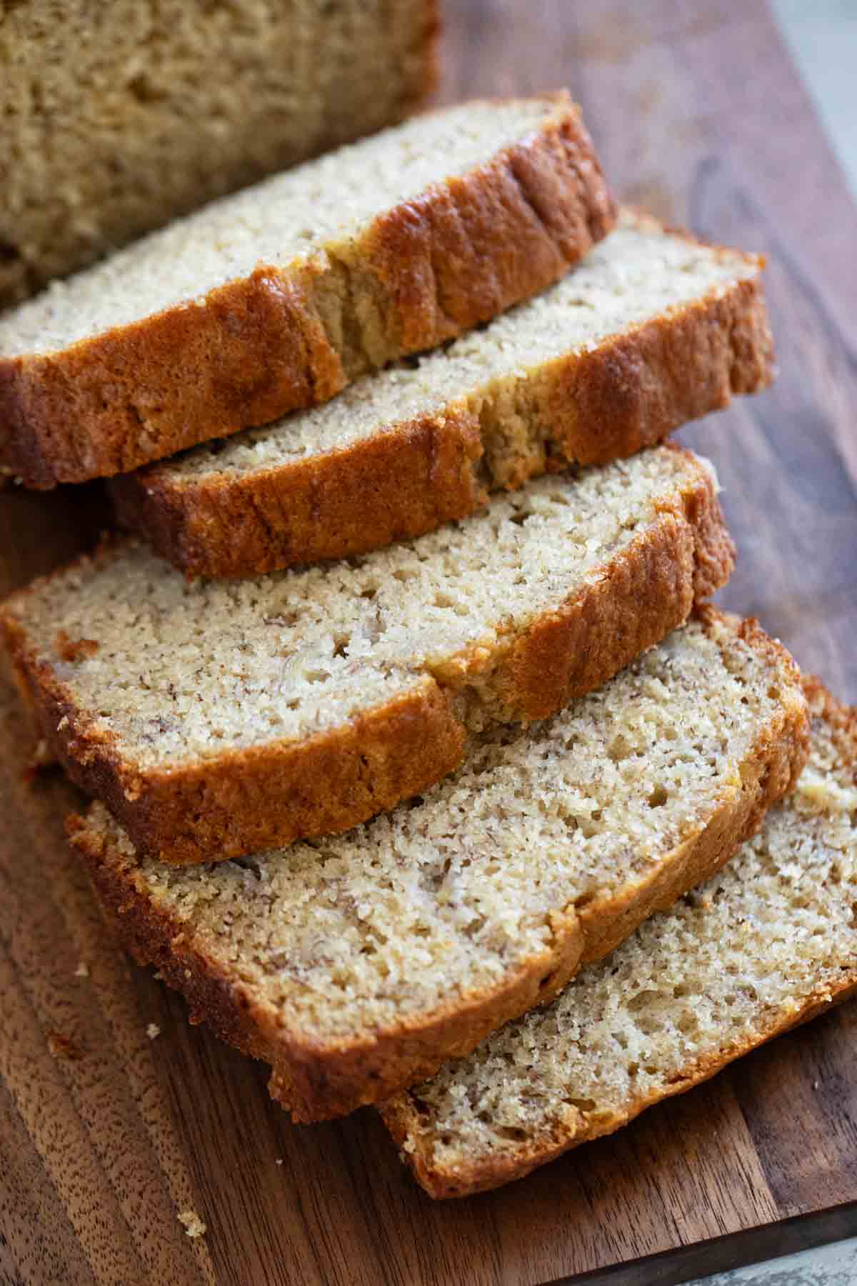 Loaf of buttermilk banana bread cut into slices.