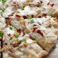 Chicken Alfredo Pizza with bacon and green onions.