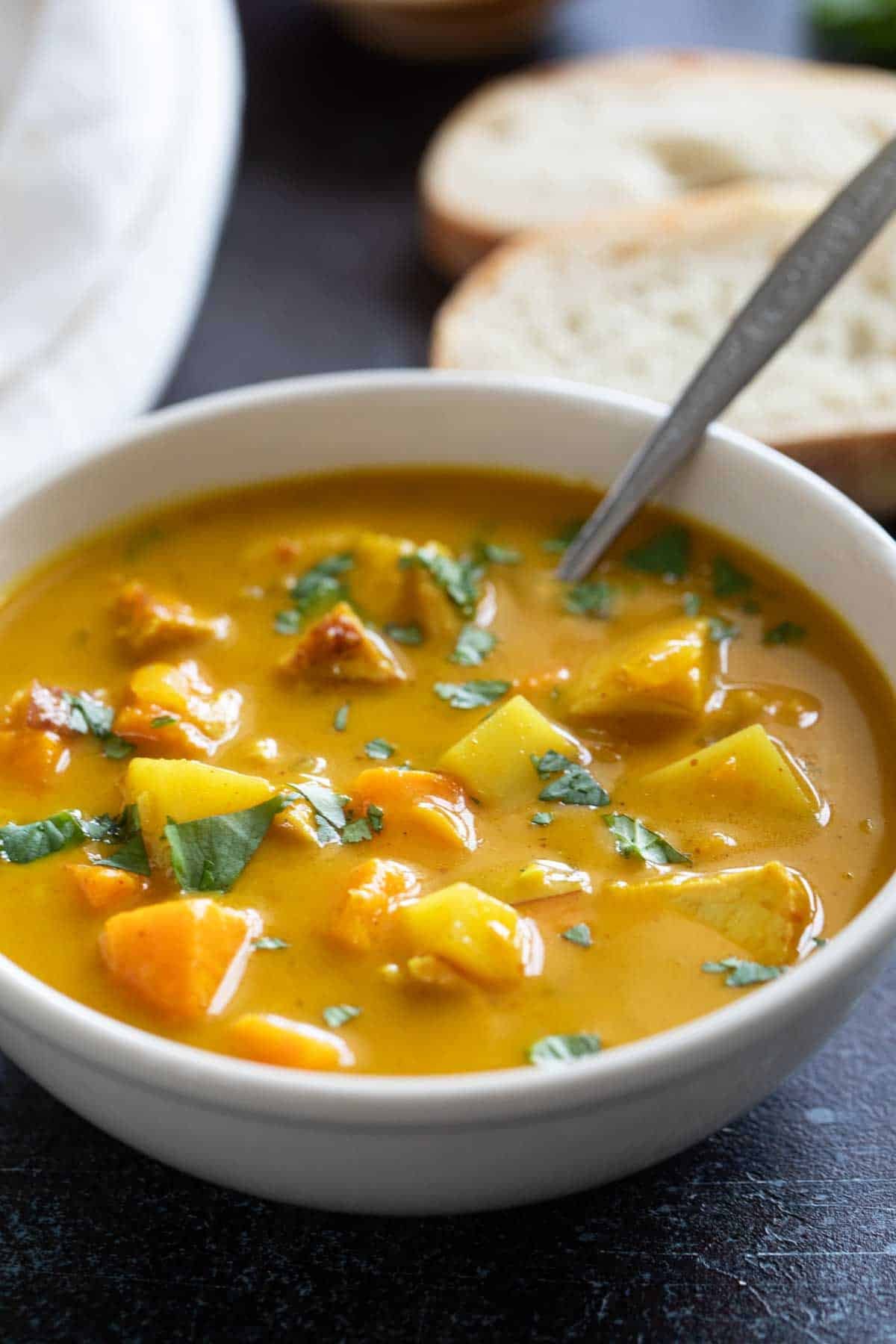 Bowl of Chicken Curry Soup topped with cilantro.