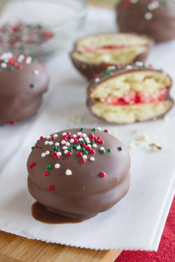 Chocolate Cherry Sandwich Cookies topped with Christmas sprinkles.