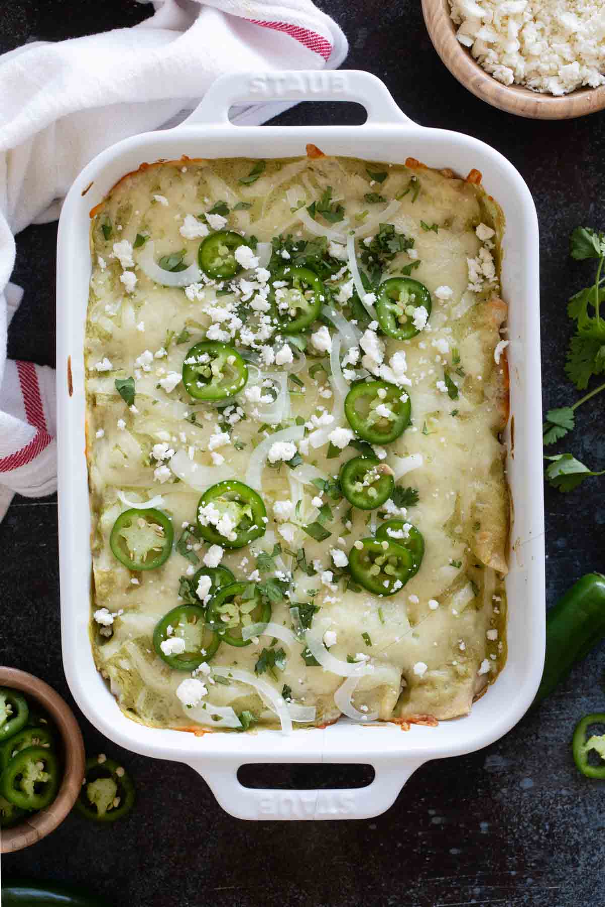 Casserole dish full of Enchiladas Suizas.