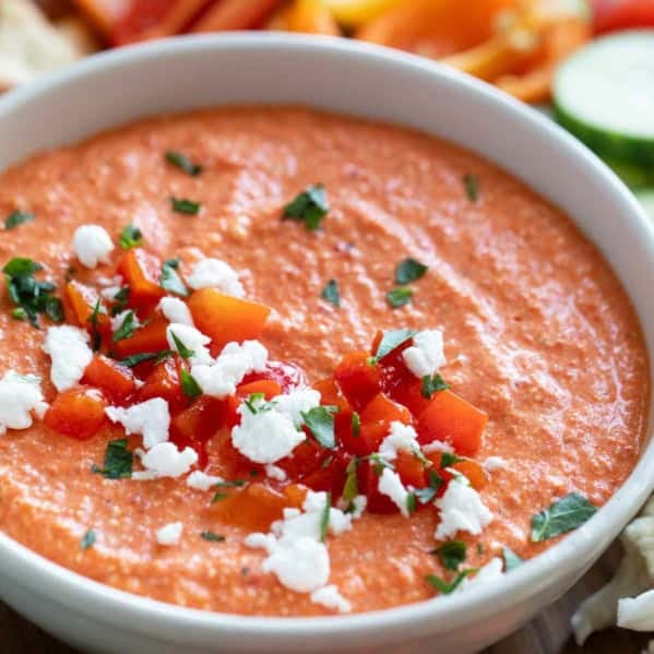 Bowl of Feta and Roasted Red Pepper Dip (Htipiti) topped with extra red peppers and feta.