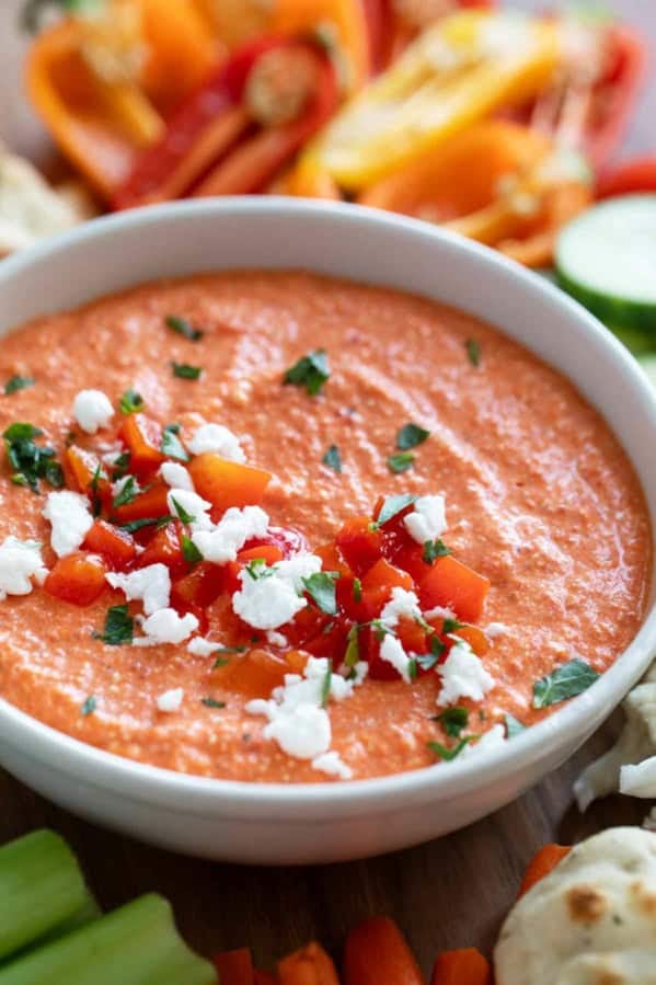 Bowl of Feta and Roasted Red Pepper Dip (Htipiti) topped with extra red peppers and feta.