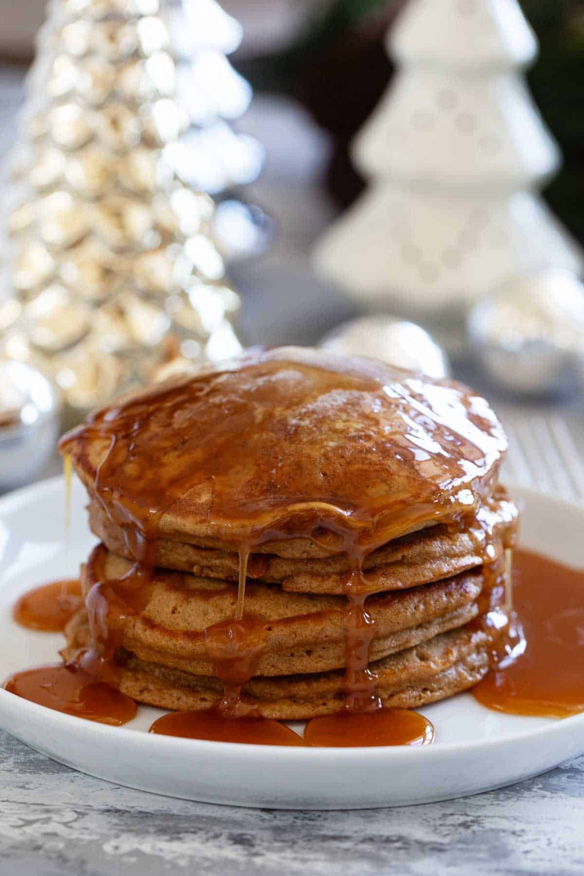 Stack of gingerbread pancakes topped with homemade buttermilk syrup.