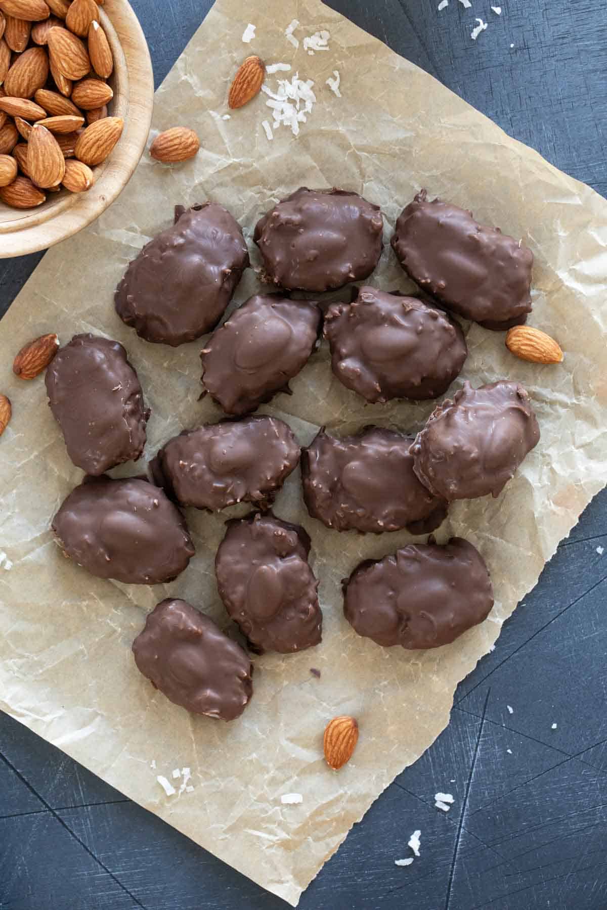 Homemade Almond Joys on a piece of parchment paper.
