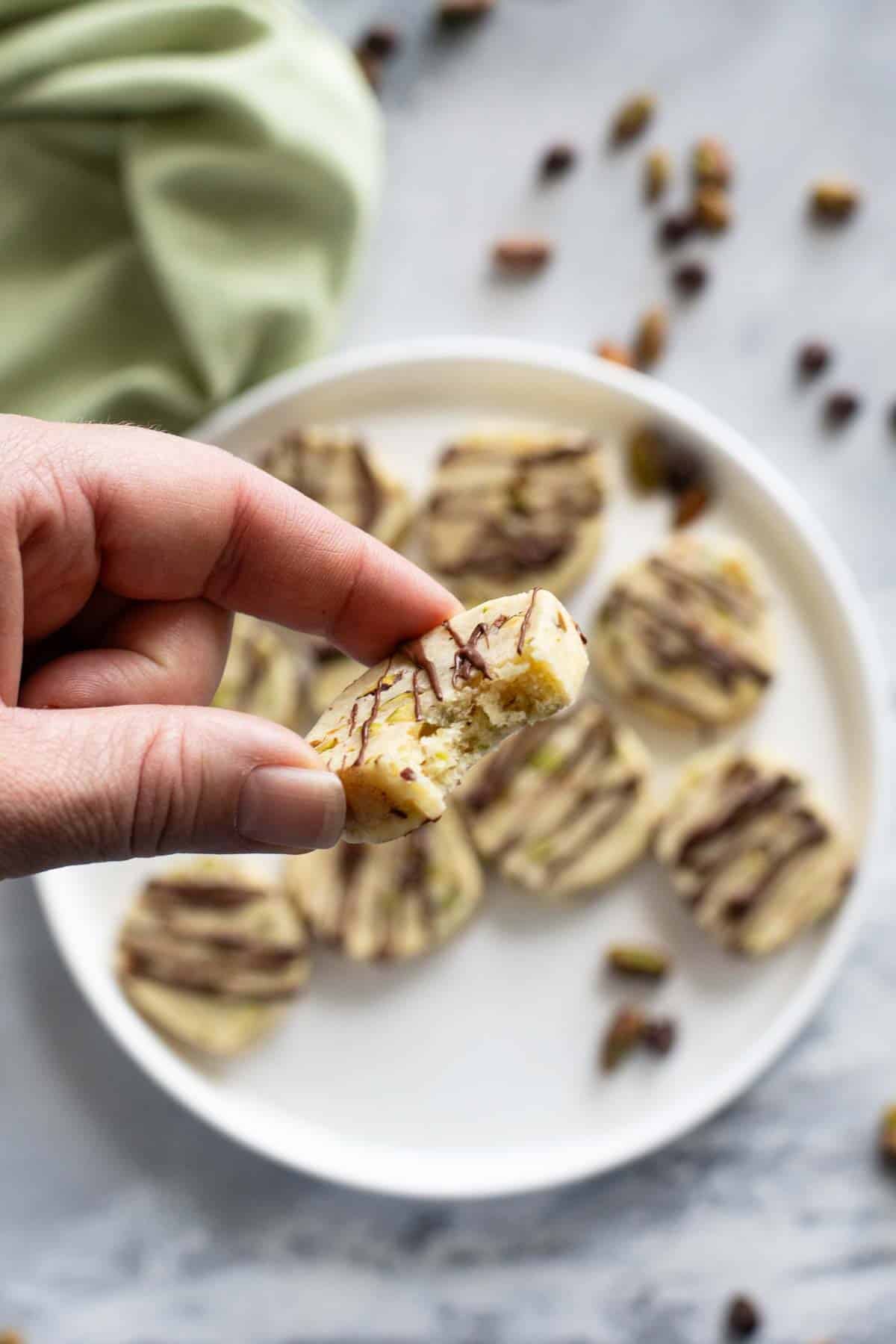 Pistachio Cookie with a bite taken from it.