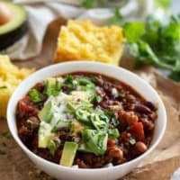 Crock Pot Chili with beef and beans in a white bowl.