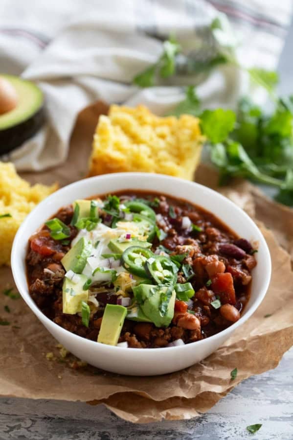 Crock Pot Chili with beef and beans in a white bowl.