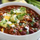 Bowl of Flatlander Chili with beef, sausage, beans, and tomatoes.
