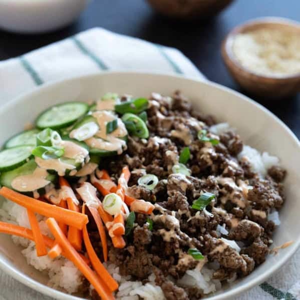 Korean Beef Bowls with carrots, cucumbers, and gochujang mayo.