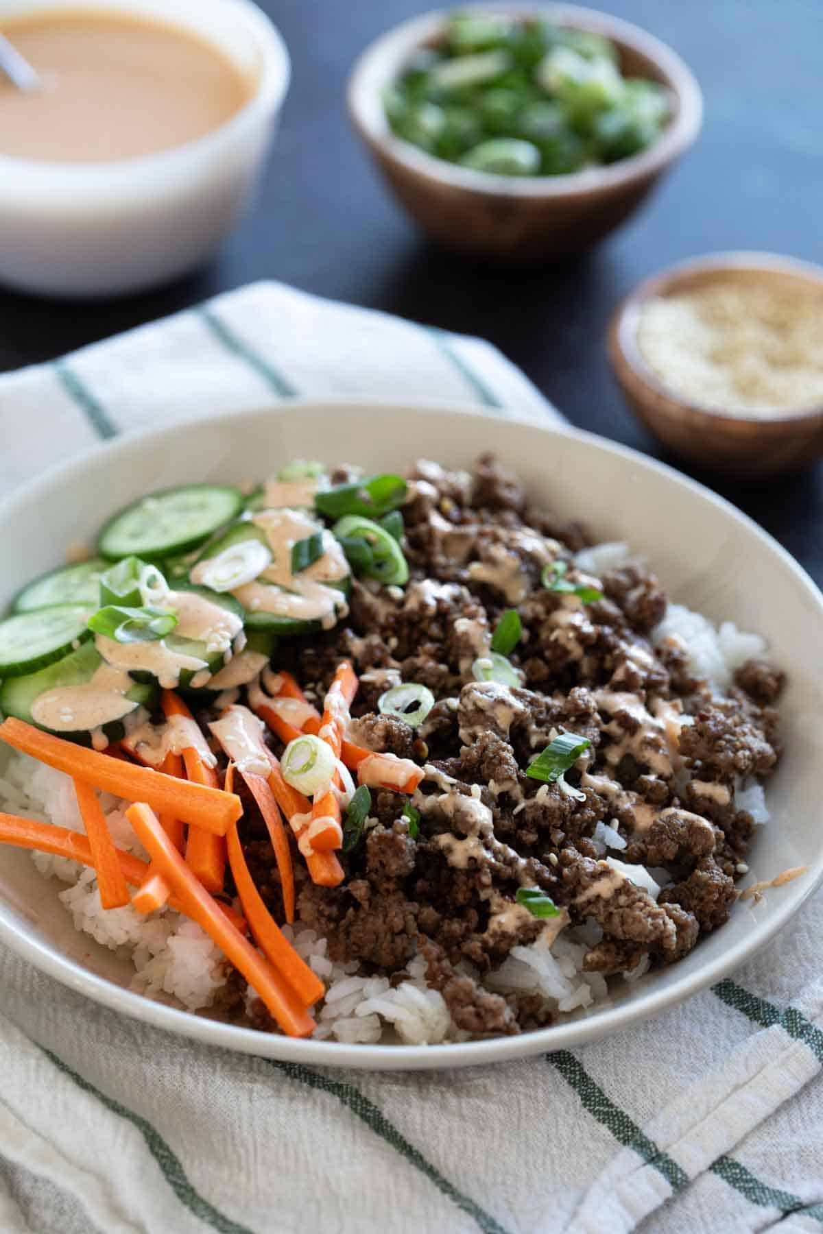 Korean Beef Bowls with carrots, cucumbers, and gochujang mayo.