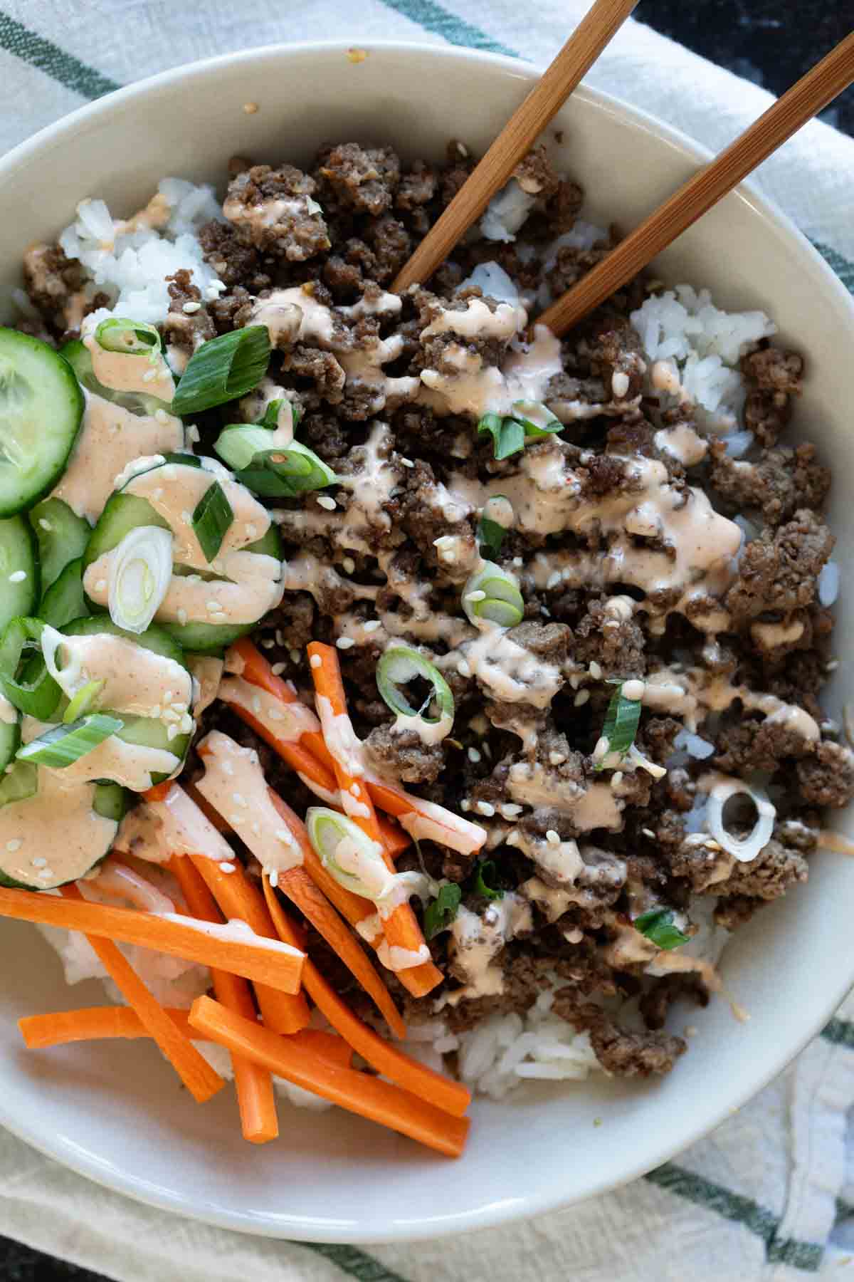 Korean Beef Bowls with carrots and cucumbers.