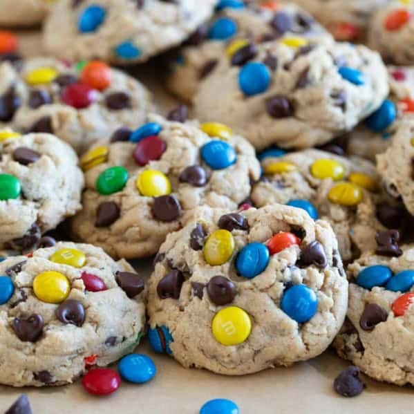 Monster Cookies stacked on a baking sheet.