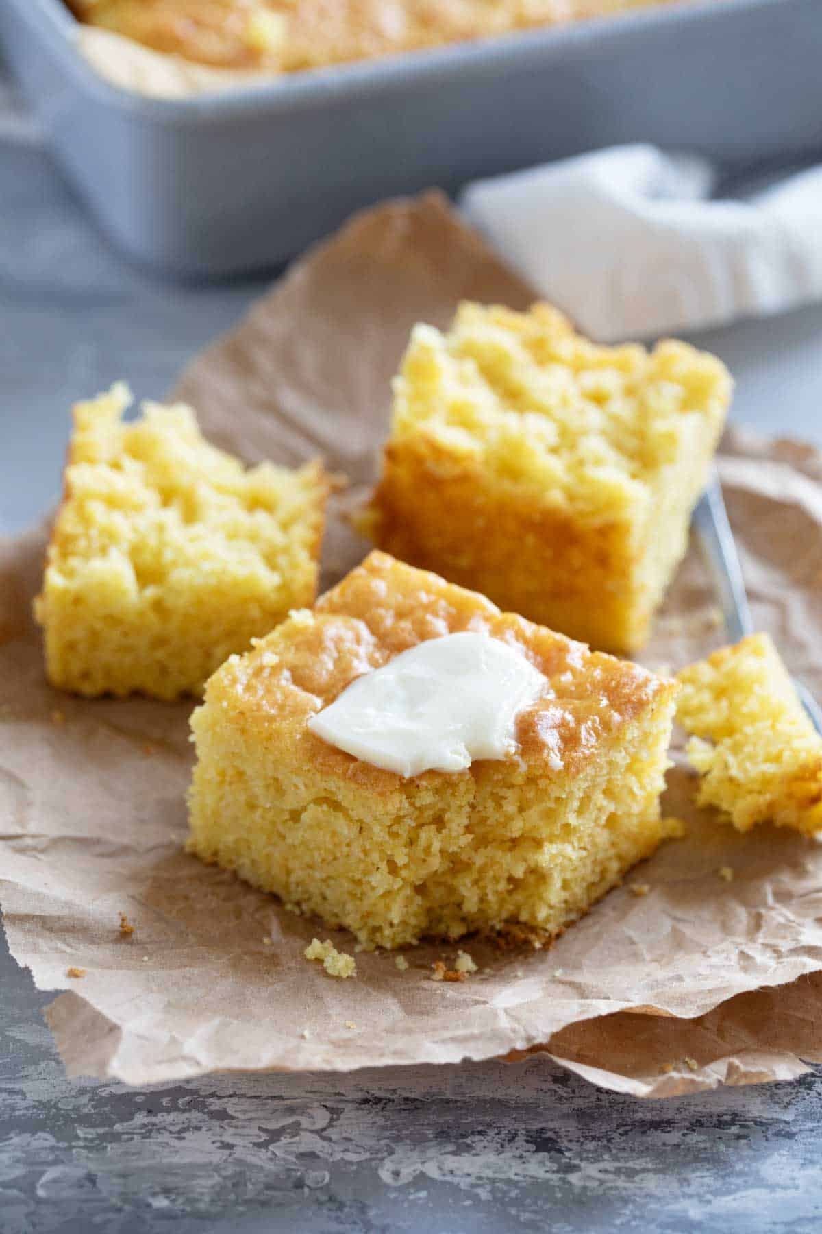 Sweet Boston Market Cornbread with a fork, topped with butter.