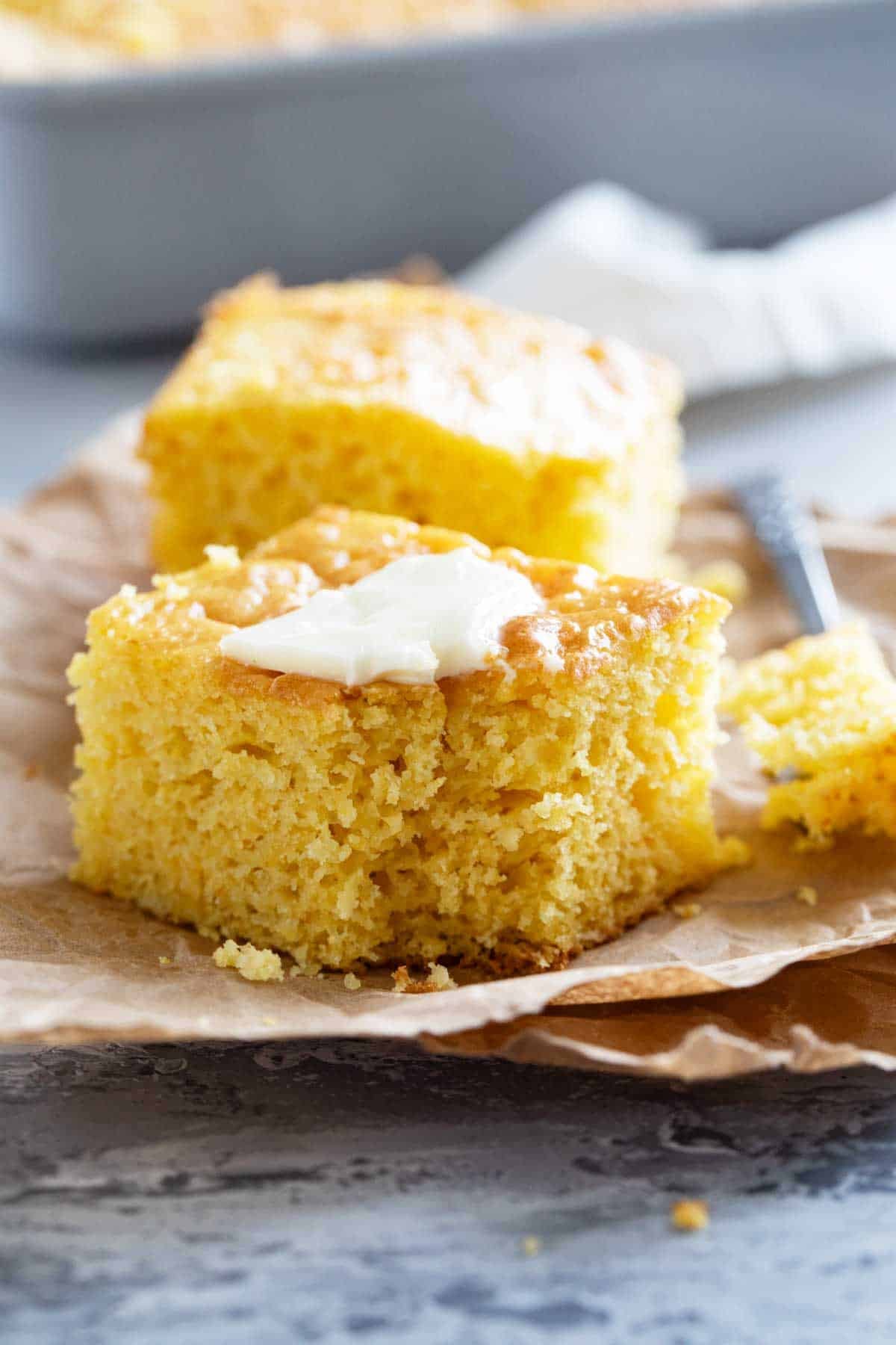 Piece of Boston Market Cornbread topped with butter.