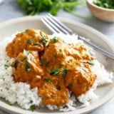 Butter Chicken Meatballs with rice, topped with cilantro.
