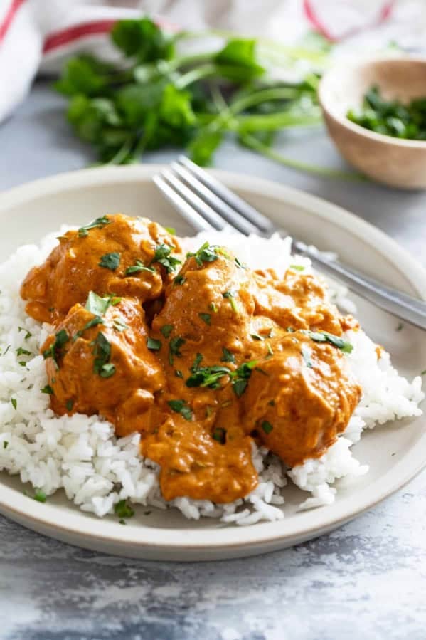 Butter Chicken Meatballs with rice, topped with cilantro.