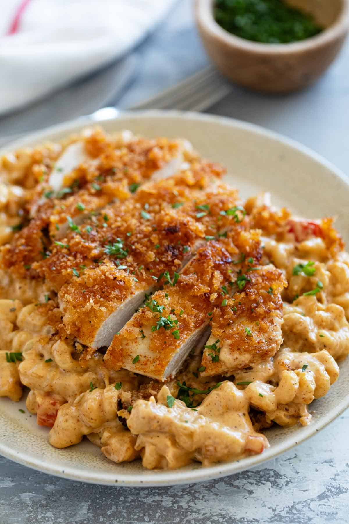 Crispy Cajun Chicken sliced and served over Cajun spiced pasta.