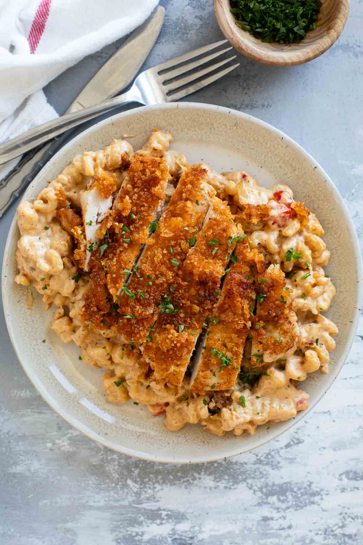 Plate with Crispy Cajun Chicken and Pasta topped with parsley.