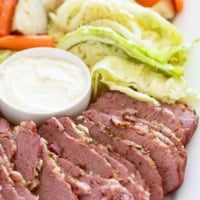Sliced corned beef, cabbage, potatoes, and carrots on a serving dish.
