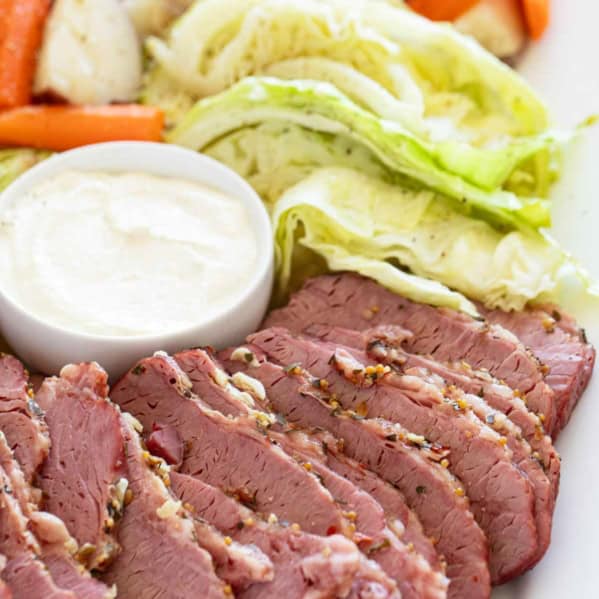 Sliced corned beef, cabbage, potatoes, and carrots on a serving dish.