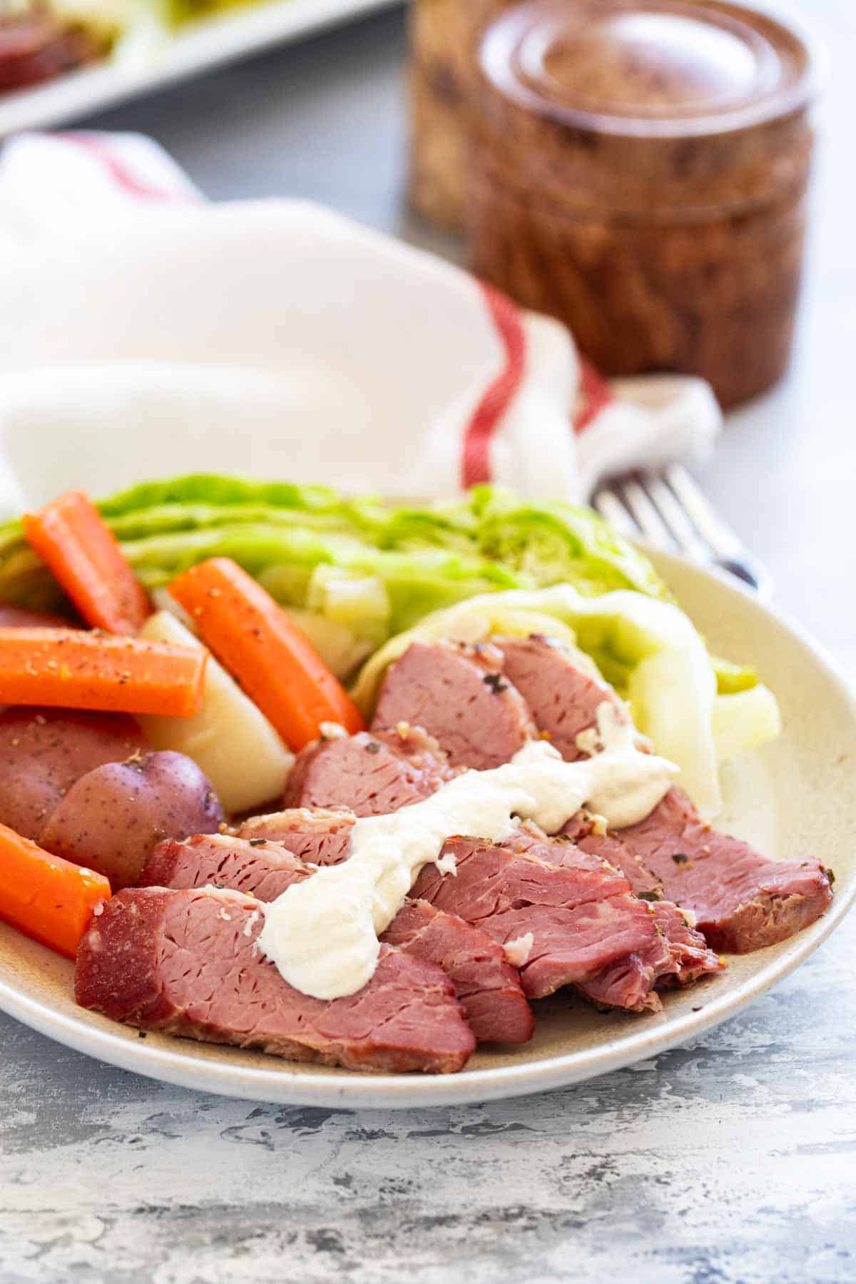 Corned Beef and Cabbage on a plate with potatoes and carrots.