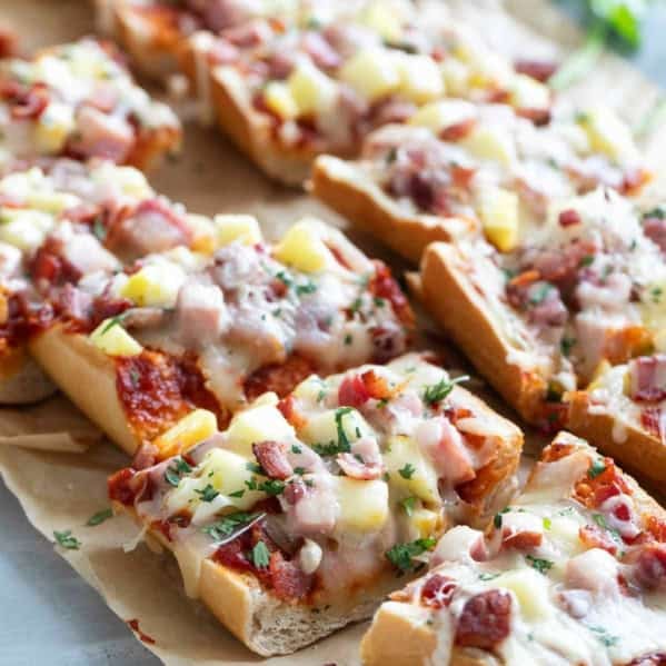 French Bread Hawaiian Pizza cut into slices, topped with fresh cilantro.