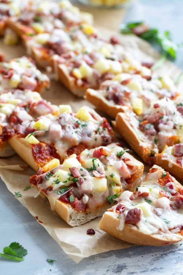 French Bread Hawaiian Pizza cut into slices, topped with fresh cilantro.