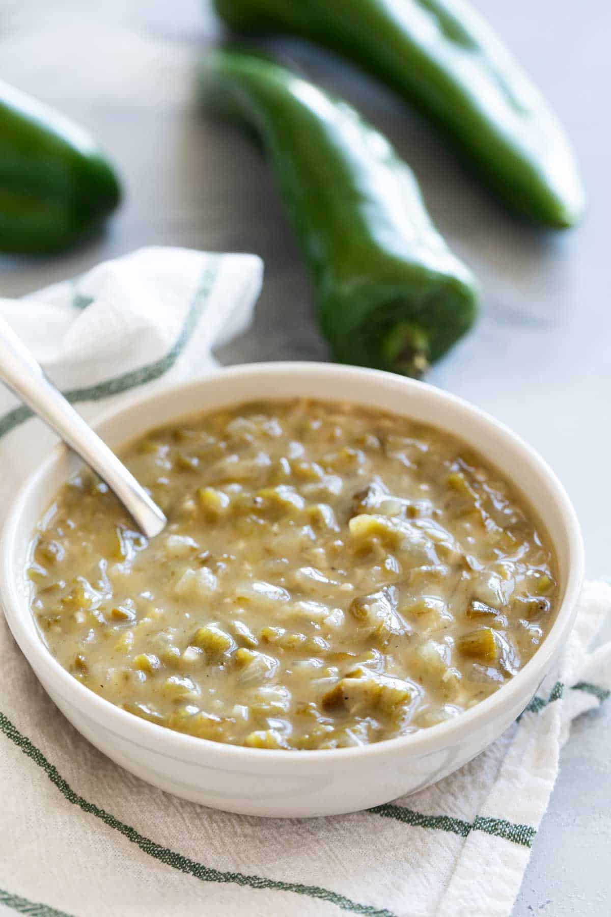 Bowl of Green Chile Sauce with a spoon in it.