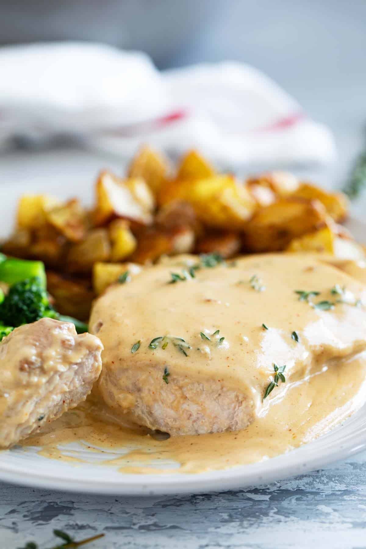 Honey Mustard Pork Chop on a plate with a bite cut from the end.