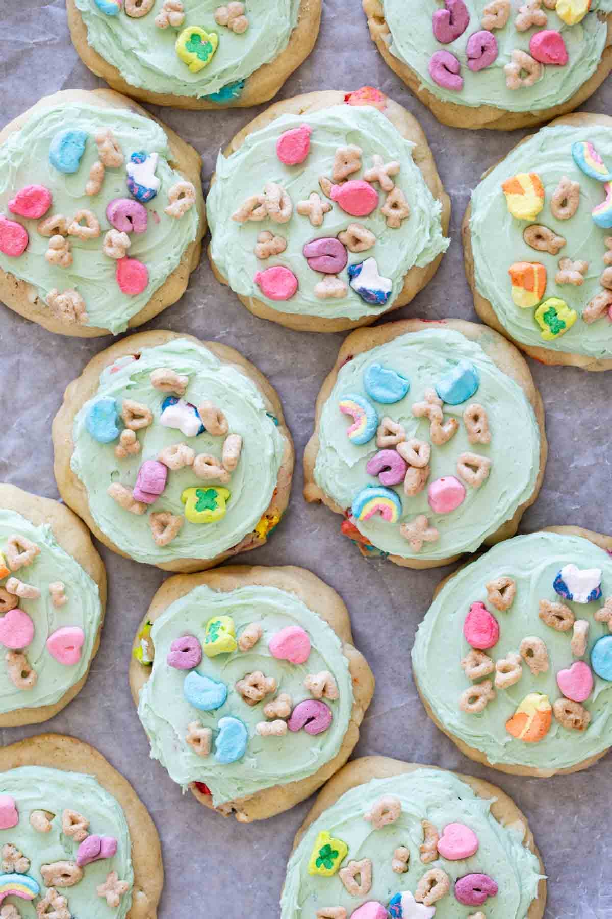 Lucky Charms Cookies filled with marshmallows and white chocolate chips and topped with Lucky Charms.