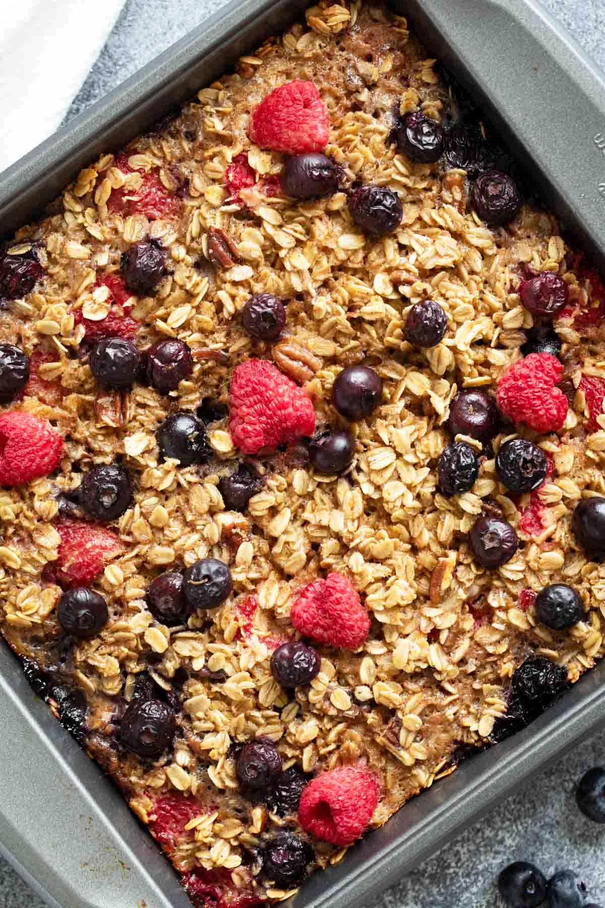 Baked Oatmeal topped with berries in a baking dish.