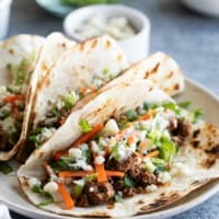 Buffalo Beef Tacos with carrots, celery, blue cheese dressing, and blue cheese crumbles.