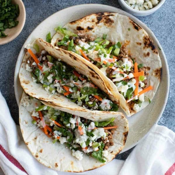 Three buffalo beef tacos made with ground beef and buffalo sauce.