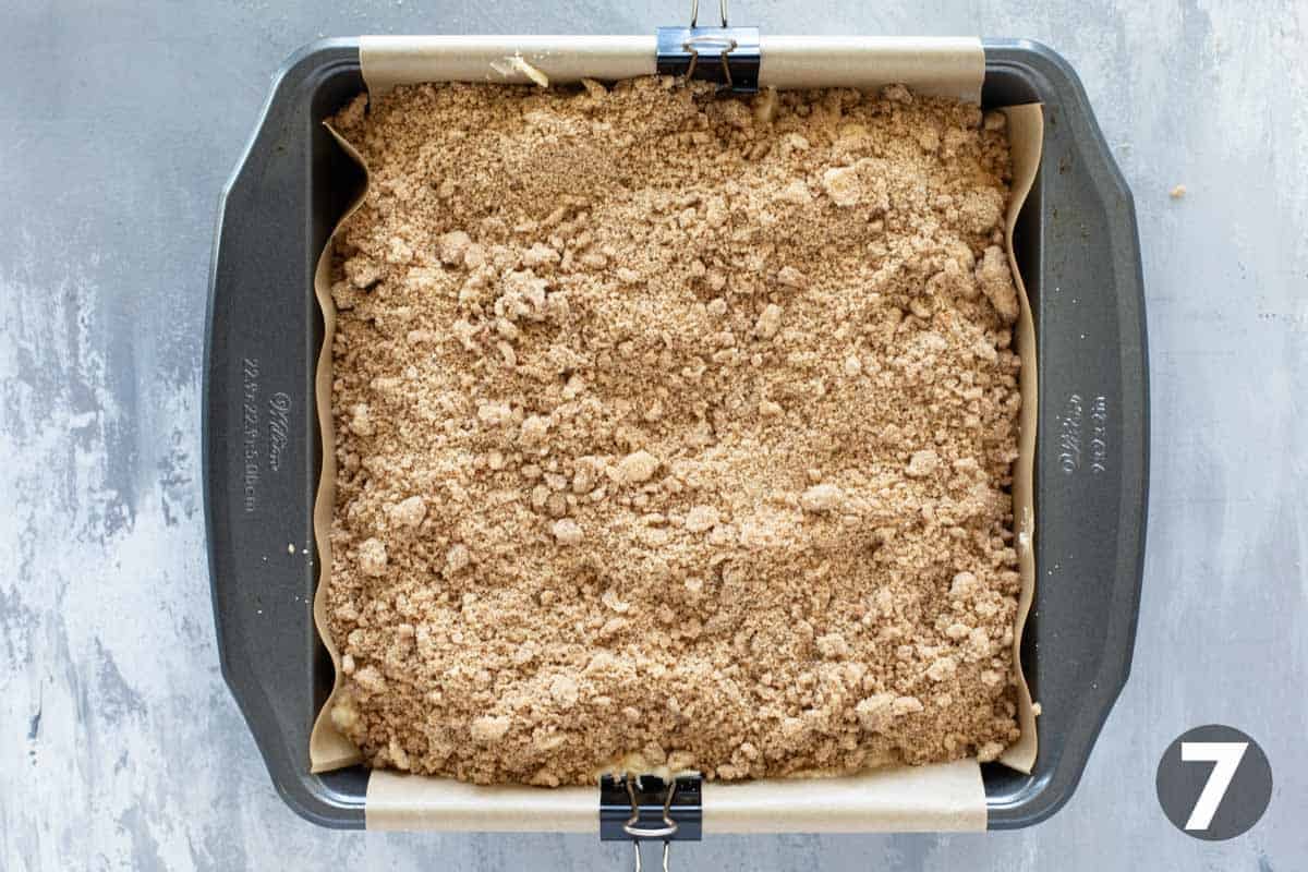 Adding top layer of crumb on a cake mix coffee cake.