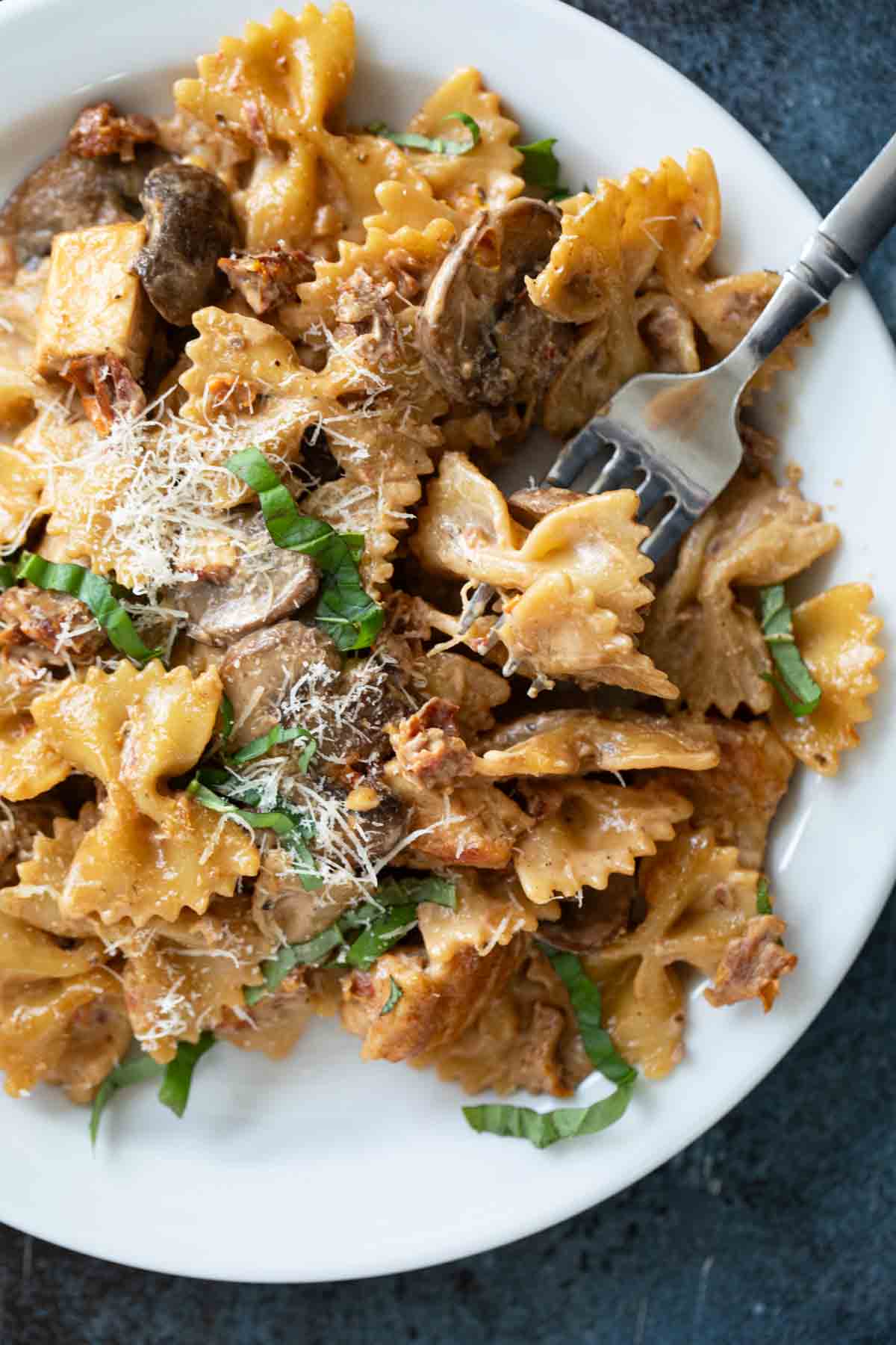 Plate with Chicken Pasta Milano with a fork.