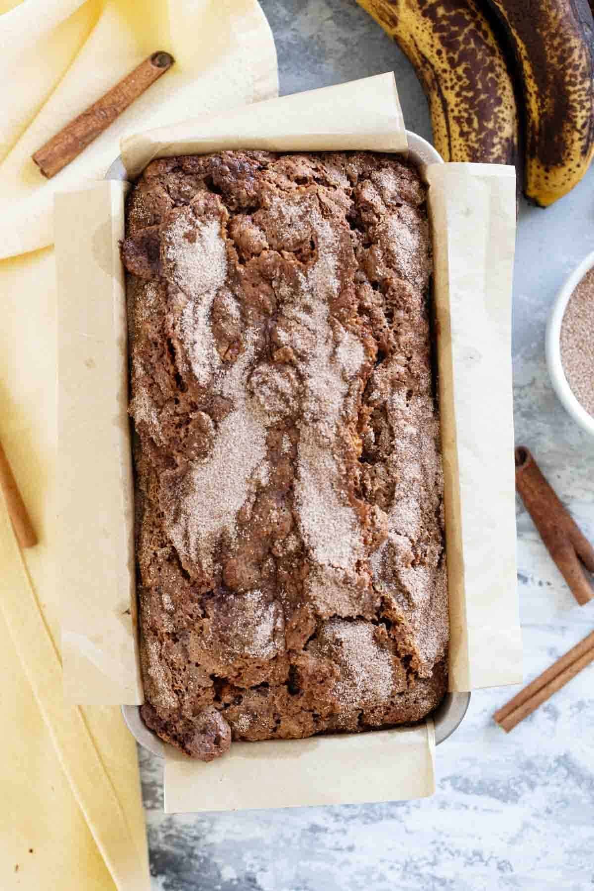 Loaf of cinnamon banana bread with a cinnamon sugar topping.