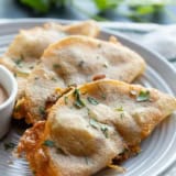 Crispy Chicken Tacos on a plate with chipotle dipping sauce.