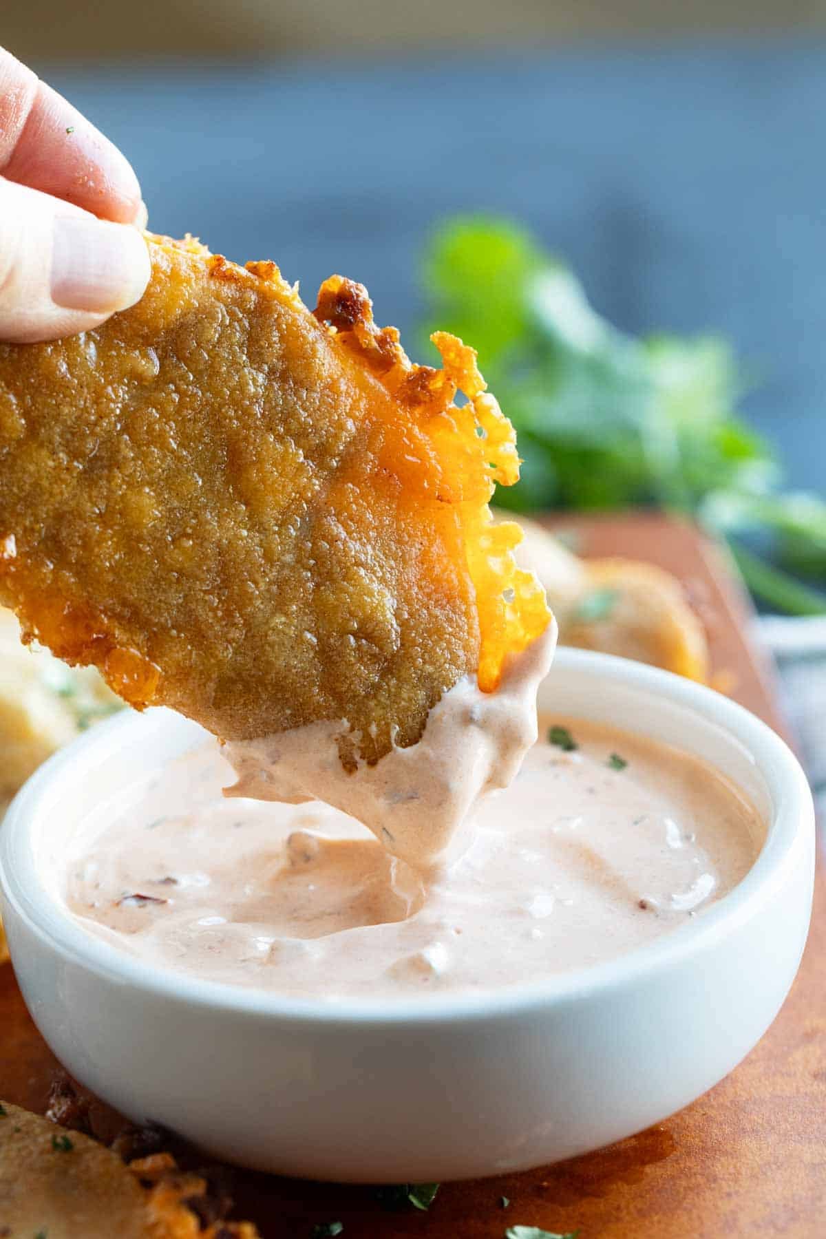 Dipping a Crispy Chicken Taco in creamy chipotle sauce.