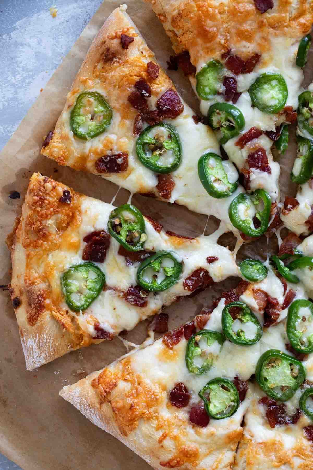 Slices of Jalapeño Popper Pizza with bacon.