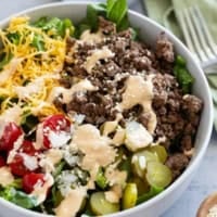 Big Mac Salad topped with sesame seeds in a bowl.