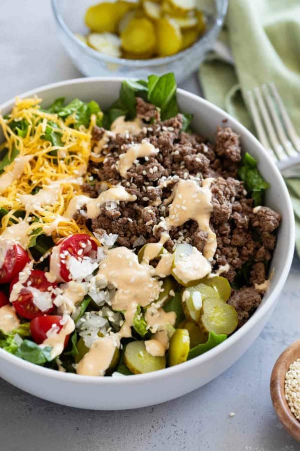 Big Mac Salad topped with sesame seeds in a bowl.
