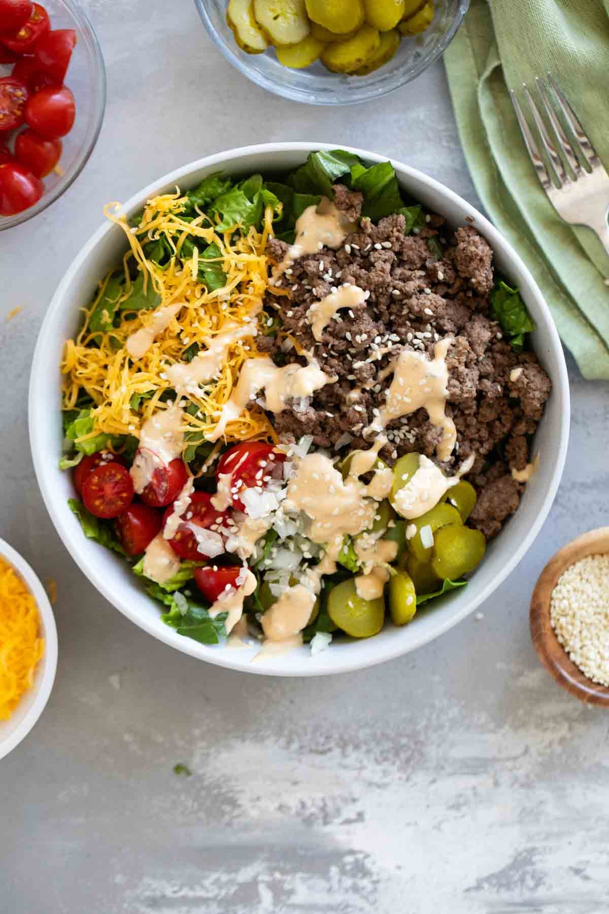 Big Mac Salad topped with beef, cheese, tomatoes, onions, pickles, and a special burger sauce.